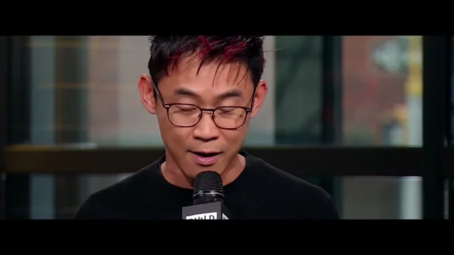 Video scene with a presenter speaking into a microphone